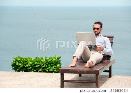 Businessman wearing a suit using laptop on the 26665684