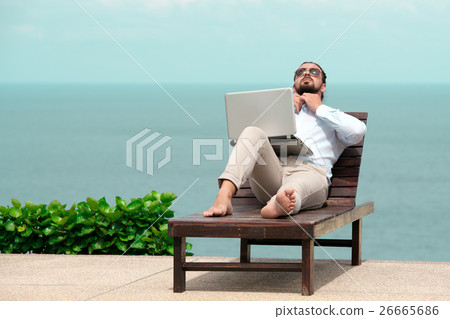 Businessman wearing a suit using laptop on the 26665686