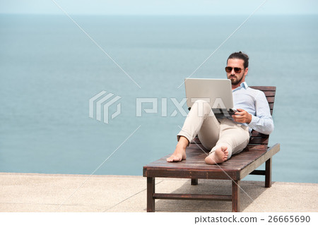 Businessman wearing a suit using laptop on the 26665690