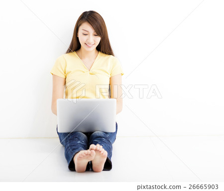 Smiling seated young woman with laptop Smiling seated young woman with laptop 26665903