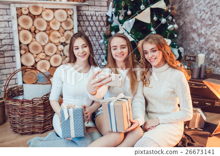 Beautiful girls sitting on the floor near a Beautiful girls sitting on the floor near a 26673141