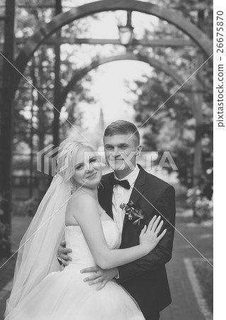 The groom gently hug the bride's shoulders The groom gently hug the bride's shoulders 26675870