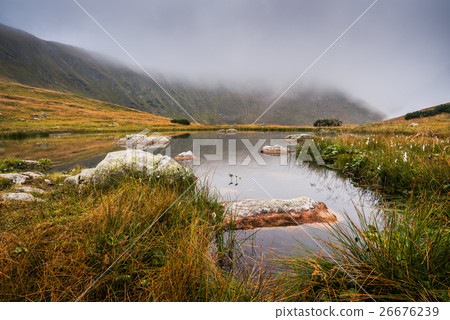Small Tarn with Rocks in Foggy Mountains Small Tarn with Rocks in Foggy Mountains 26676239