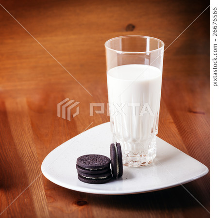 Milk and cookies on a wooden table 26676566