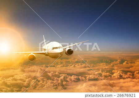 plane flying over cloud scape and sun light 26676921