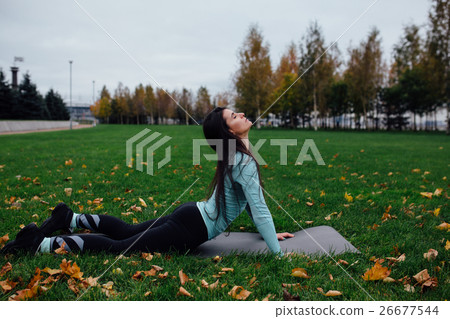 Beautiful girl stretching at the grass. Sporty Beautiful girl stretching at the grass. Sporty 26677544
