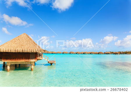 Over water bungalows with steps into green lagoon Over water bungalows with steps into green lagoon 26678402