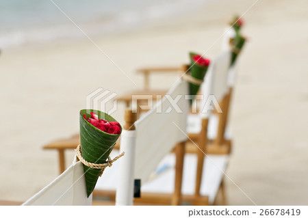 red flower in banana leaf cone decoration on beach 26678419
