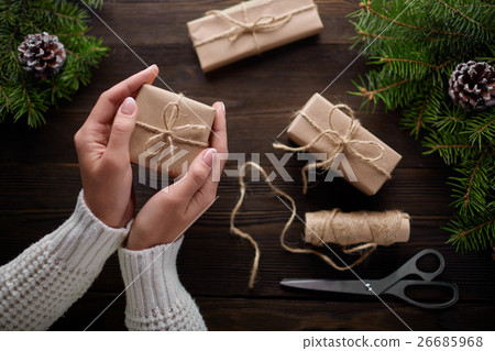 Beautiful female hands are packed Christmas gift Beautiful female hands are packed Christmas gift 26685968