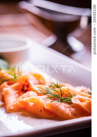 Sliced smoked salmon with dressing and herb dill. Sliced smoked salmon with dressing and herb dill. 26688186