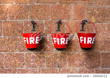 Red fire bin on brick wall background Red fire bin on brick wall background 26688222