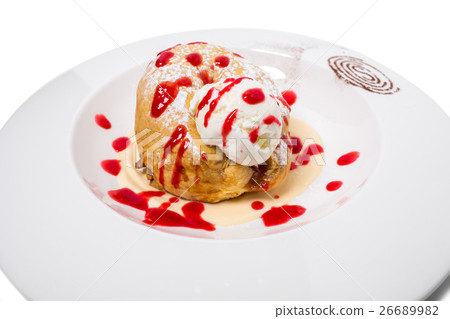 Cinnamon bun with ice cream. 26689982