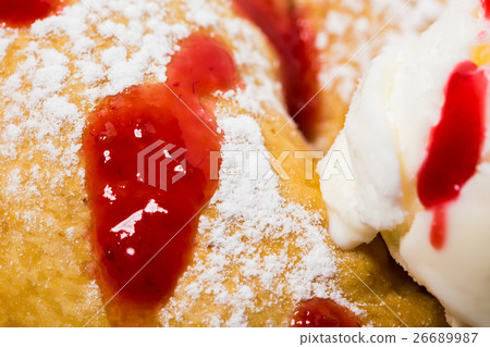 Cinnamon bun with ice cream. 26689987