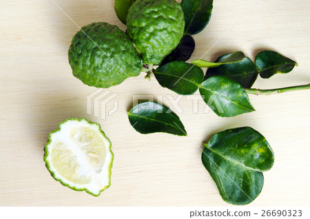 Bergamot fruit with leaf on wooden board Bergamot fruit with leaf on wooden board 26690323