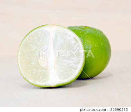 Lemon or lime fruit with half cross section 26690325