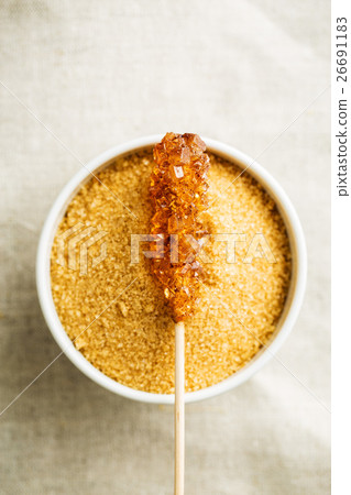 Brown amber sugar crystal on wooden stick. 26691183