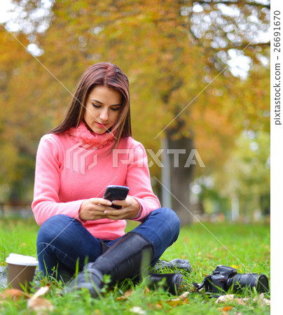 Young fashionable teenage girl with smartphone Young fashionable teenage girl with smartphone 26691670