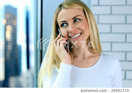 Portrait of happy woman Talking On Mobile Phone 26691714