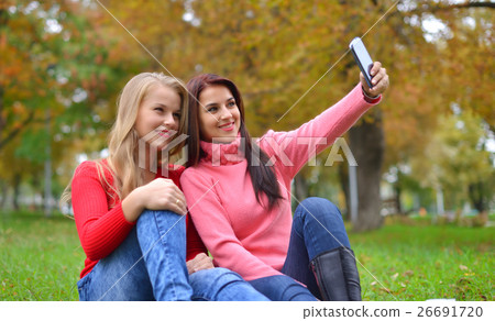 two beautiful young women making selfie two beautiful young women making selfie 26691720