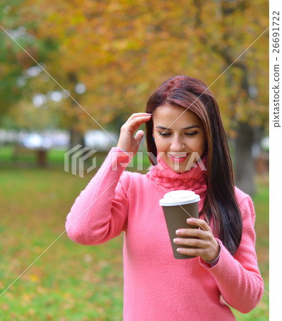 woman in autumn outdoors with cup of coffee 26691722