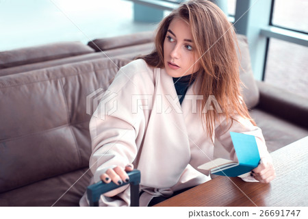 Woman sitting on the couch in a hall Woman sitting on the couch in a hall 26691747