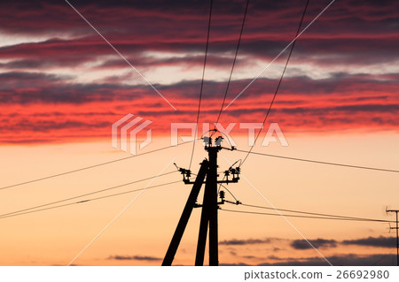 Electric line against colorful sky at sunset 26692980