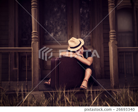 Woman sitting on threshold of old house. Woman sitting on threshold of old house. 26693340