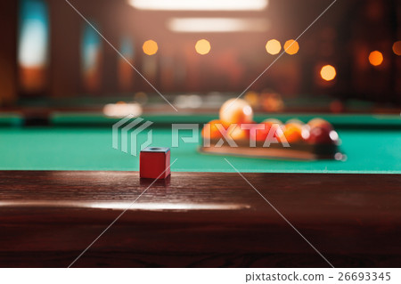 Chalk on the edge of the billiard table. 26693345