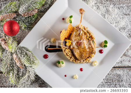 roasted duck leg with mash and sauce on plate 26693393