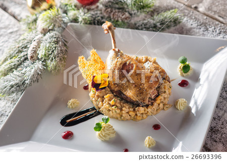 roasted duck leg with mash and sauce on plate 26693396