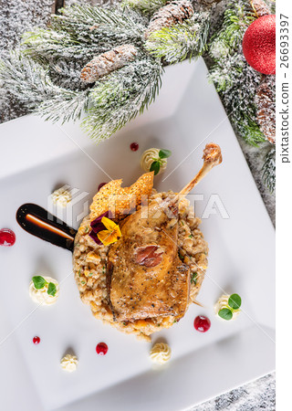 roasted duck leg with mash and sauce on plate 26693397