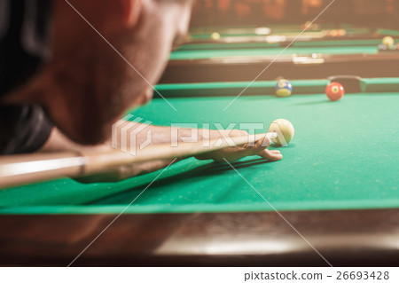 Man trying to hit the ball in billiard. Man trying to hit the ball in billiard. 26693428