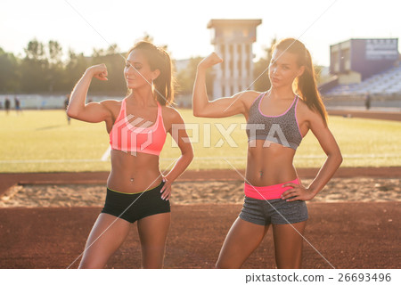 Sporty young women with perfect bodies showing Sporty young women with perfect bodies showing 26693496