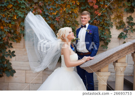 Stylish newlyweds posing for a walk in the photo Stylish newlyweds posing for a walk in the photo 26693753