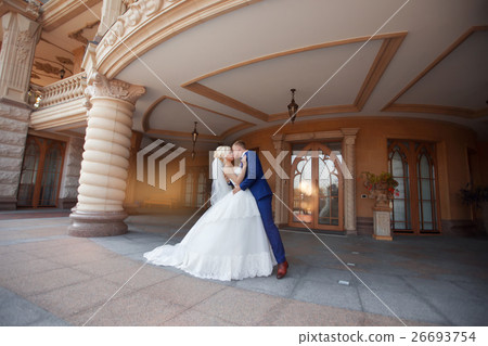 Newlyweds kissing standing under the balcony Newlyweds kissing standing under the balcony 26693754