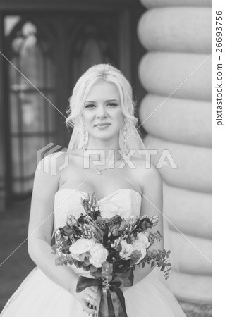 Black and white photo of the bride with a bouquet flowers Black and white photo of the bride with a bouquet flowers 26693756