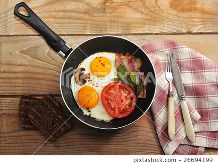 bacon and eggs and mushrooms with the pan bacon and eggs and mushrooms with the pan 26694199