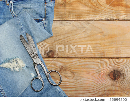 Jeans and scissor on wooden background dark tone Jeans and scissor on wooden background dark tone 26694200