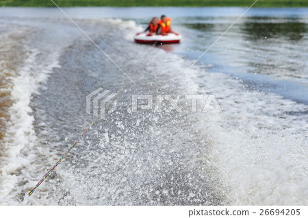 two people ride on a water tube two people ride on a water tube 26694205