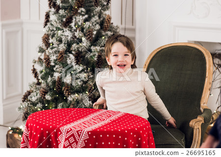Portrait of cute kid boy sitting on green chair Portrait of cute kid boy sitting on green chair 26695165