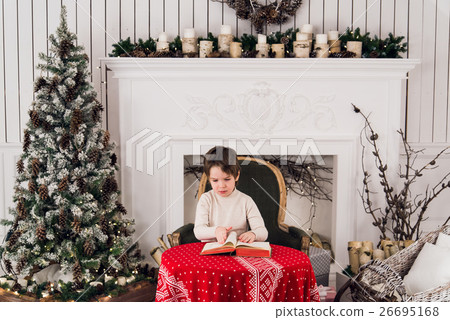 Portrait of cute kid boy sitting on green chair 26695168