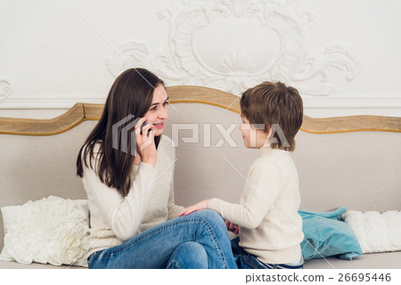 family phone talking - cute little boy, his mother family phone talking - cute little boy, his mother 26695446