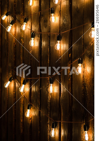 Designer light bulbs on dark wooden background 26695646