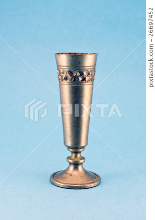 vintage metal goblet cup on blue background 26697452