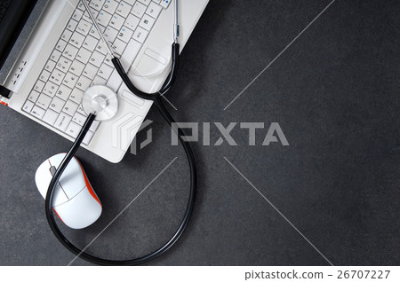 Laptop and a stethoscope on the desk. Laptop and a stethoscope on the desk. 26707227