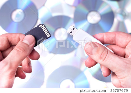 Man's hands with SD card and pendrive Man's hands with SD card and pendrive 26707679