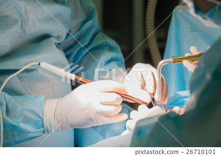 Surgeon holding instrument during cosmetic surgery 26710101