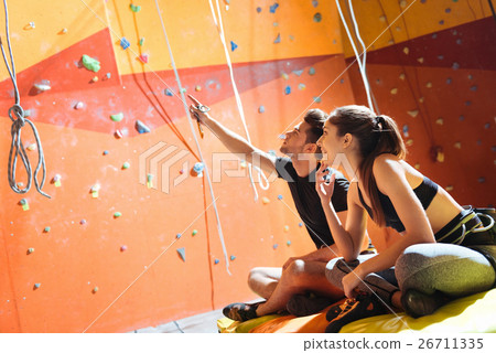 Happy couple sitting in a climbing gym 26711335
