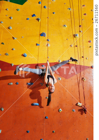 Active woman making a trick on  climbing wall 26711560