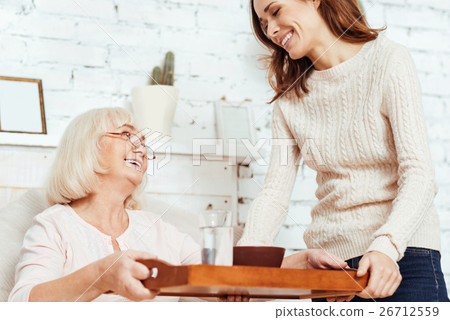 Cheerful caring woman takign care of her 26712559